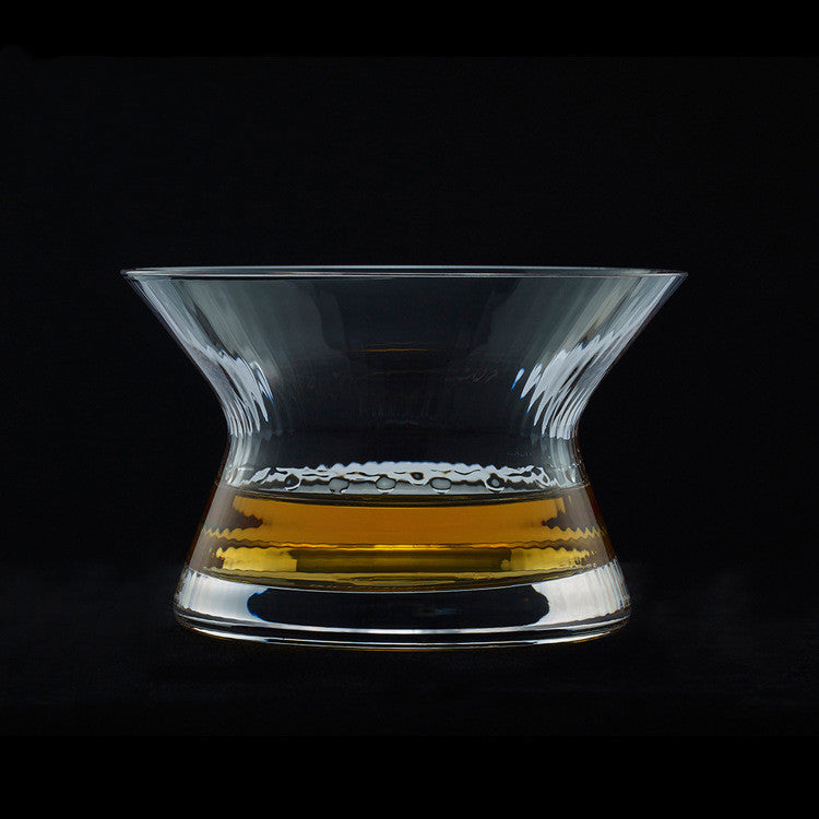 Whiskey glass with rotating spirits