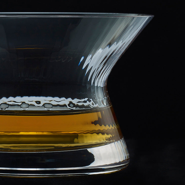 Whiskey glass with rotating spirits