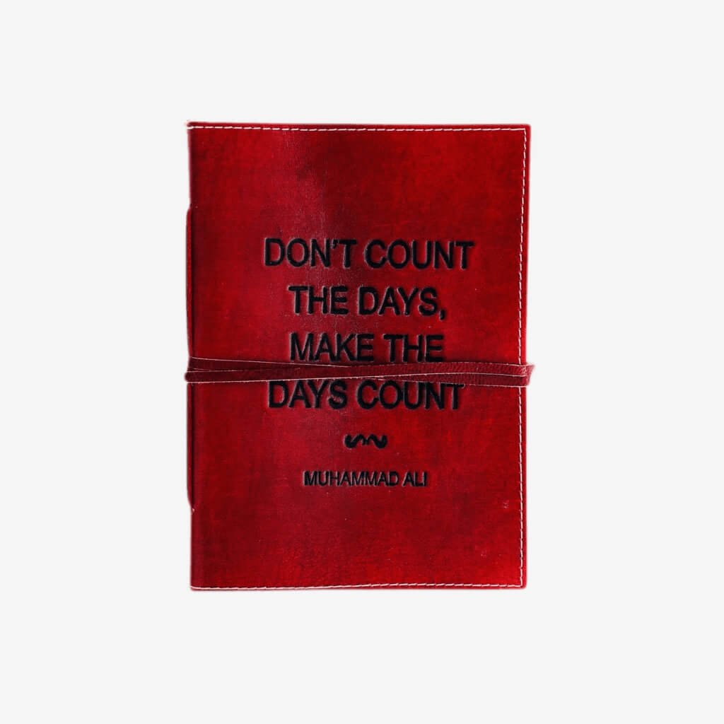 Genuine Leather Notebook with Embossed Saying &quot;Don&#39;t Count The Days Make The Days Count&quot; Leather books will never go out of style. These genuine leather bound books are full of handmade paper that is hand stitched together. With a wonderful embossed saying this notebooks is the perfect gift to those who journal.